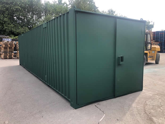 used storage shipping container painted in green